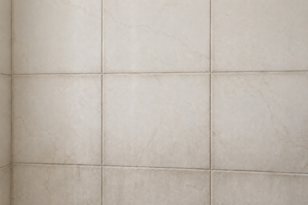The same tile with grey soap scum along the grout and a dull film across the surface