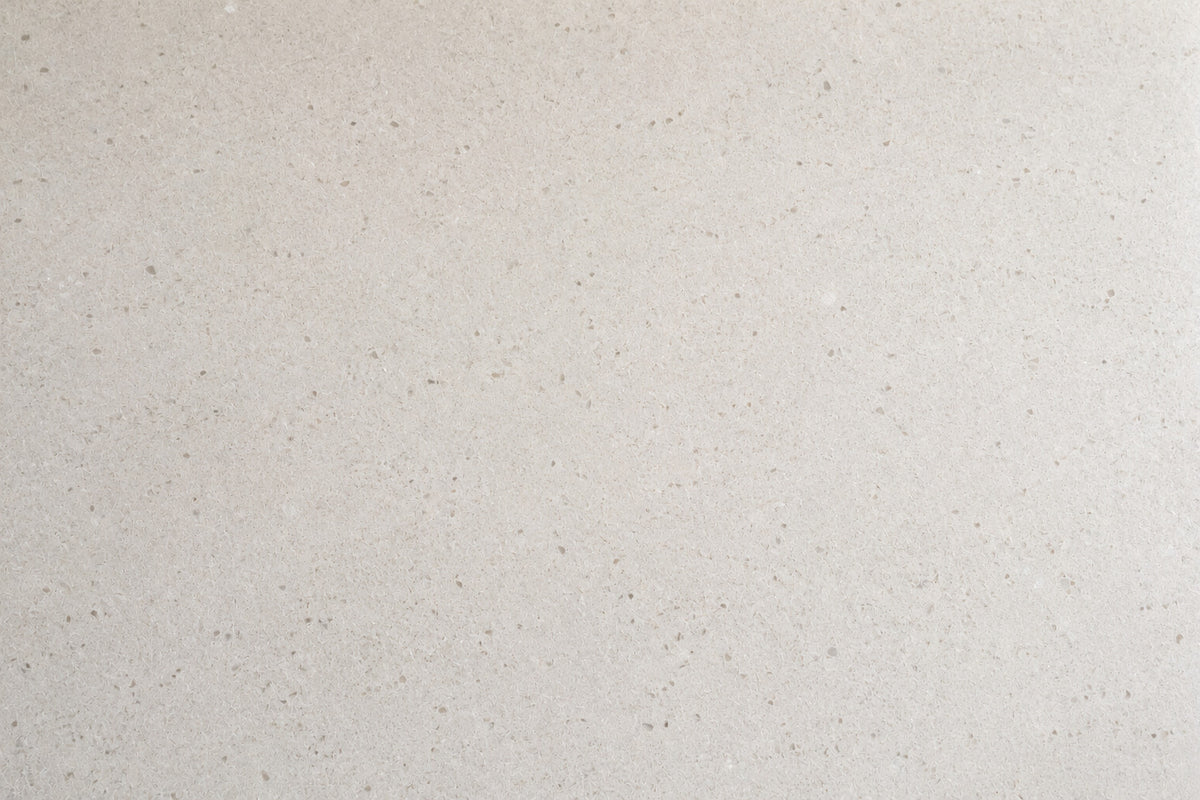 A pale stone kitchen worktop, clean and empty